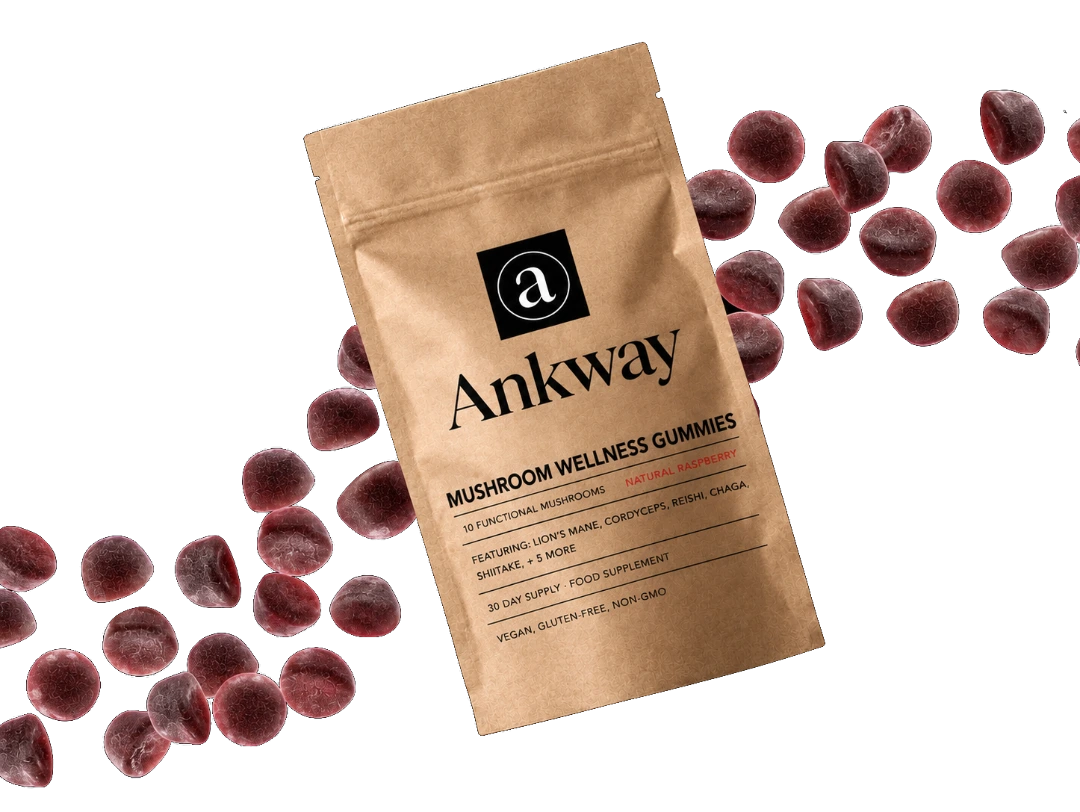 Brown package labeled 'Ankway Mushroom Gummies' surrounded by scattered dark gummies.